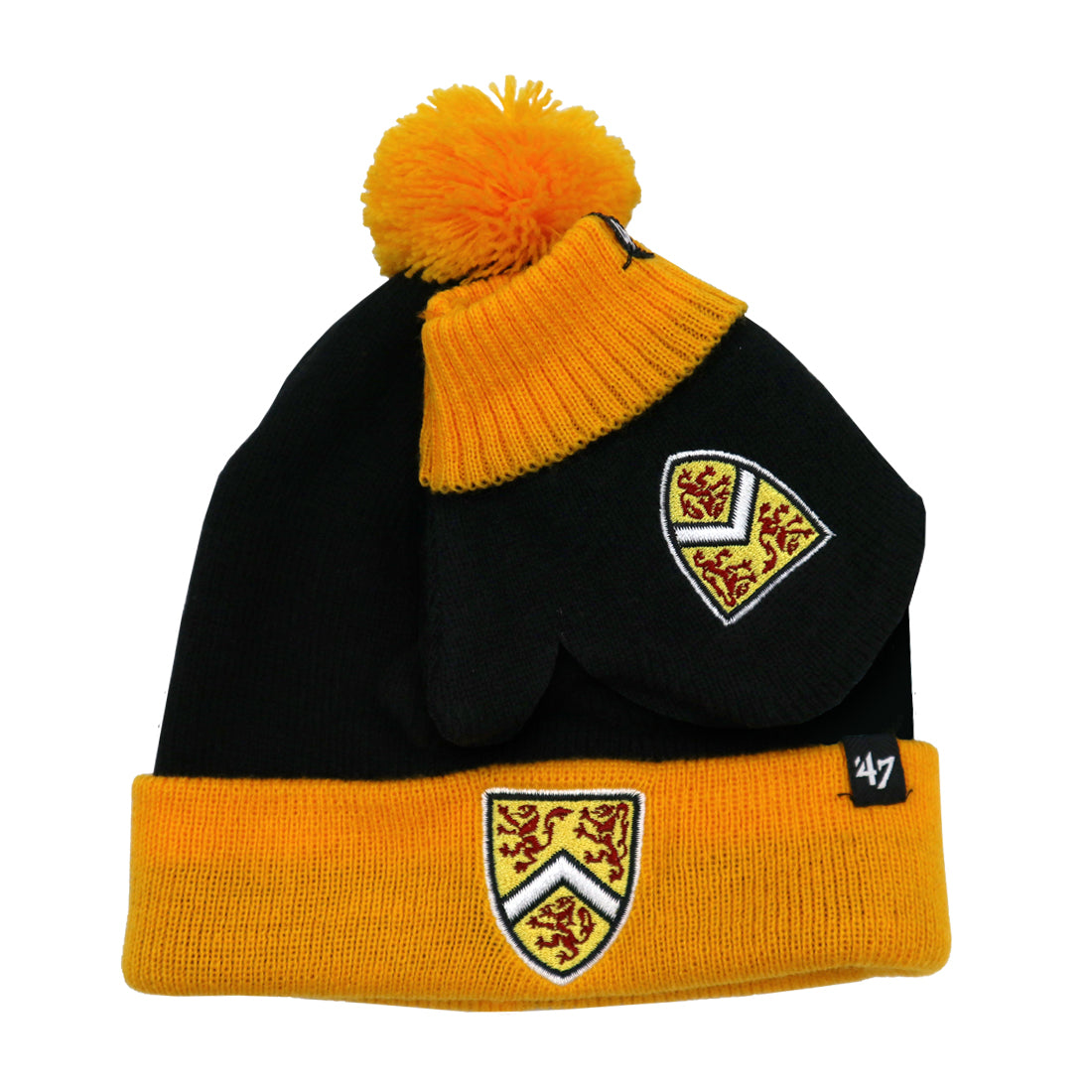 A black and yellow knit beanie with a pom-pom on top and a pair of matching black mittens, both featuring a crest design.