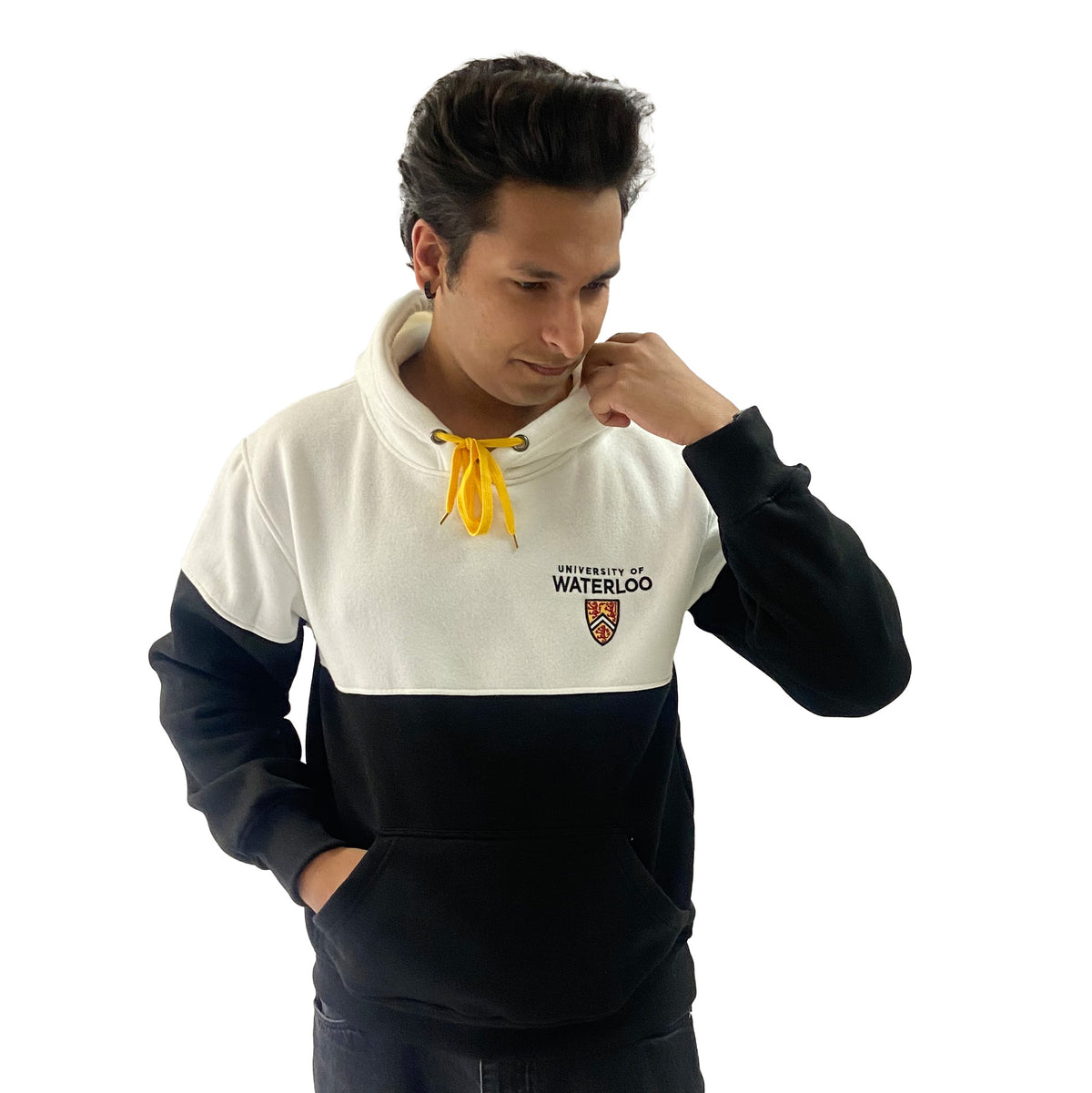 A person wearing a black and white hoodie with "University of Waterloo" printed on it, standing with one hand on their chin.