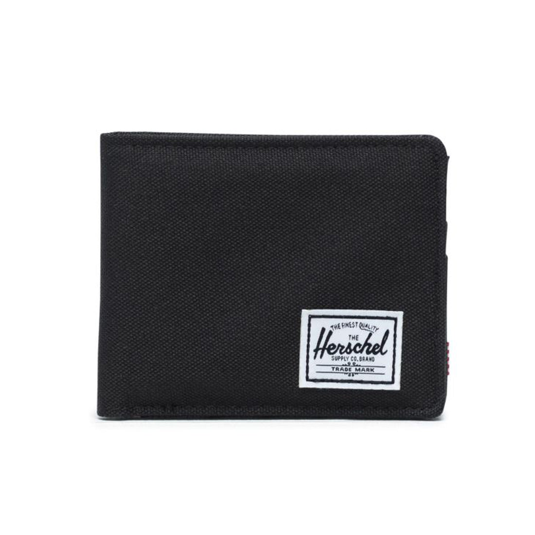 Black wallet with a white Herschel logo tag on the front.
