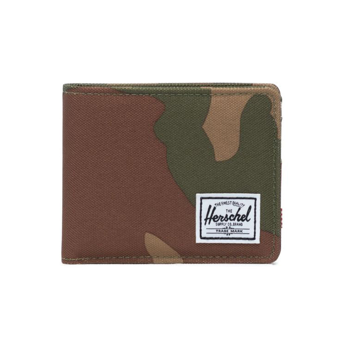 A folded brown and green camouflage wallet featuring a white Herschel brand label on the front.