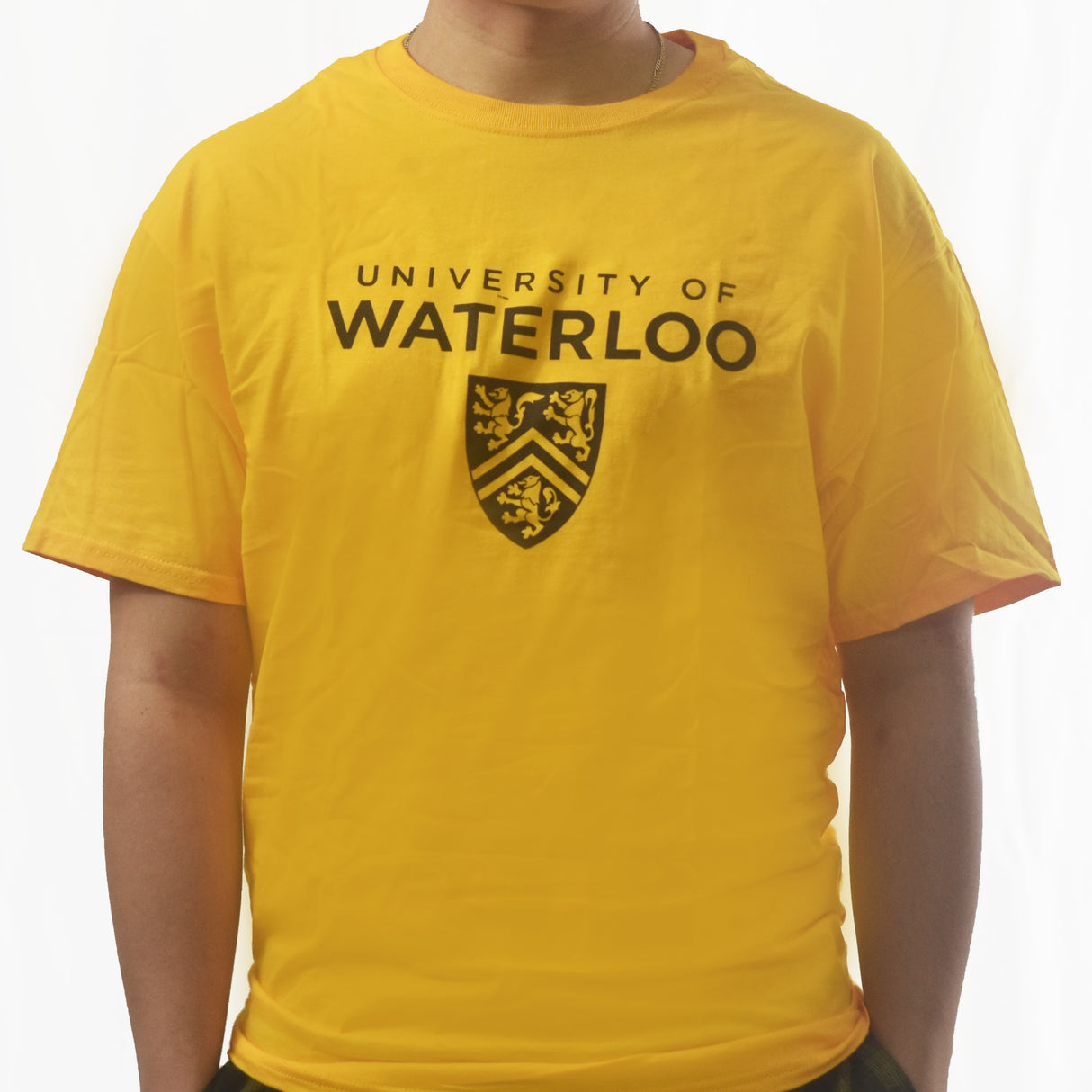A person wearing a yellow t-shirt with "University of Waterloo" printed in black above a shield logo.