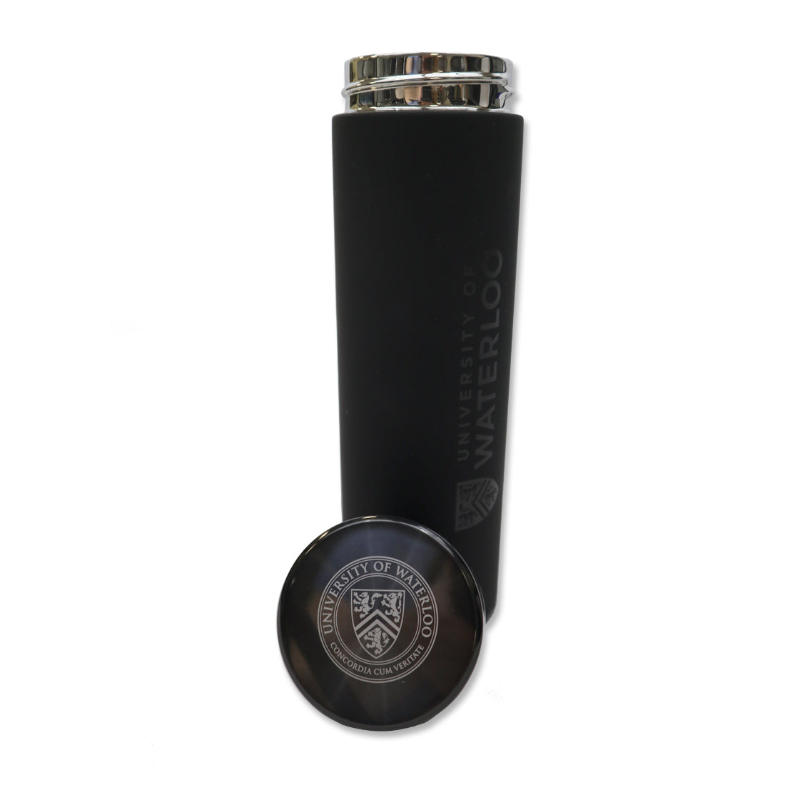 A black insulated water bottle with a metallic lid, featuring the University of Waterloo logo engraved on the side, next to a round, silver-colored coaster with the same logo.