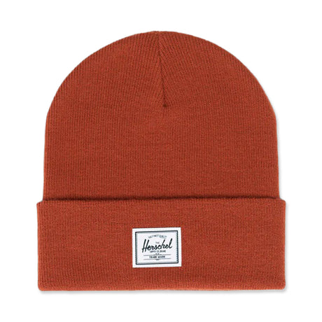 Rust-colored knit beanie with a folded cuff and a Herschel logo patch.