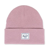 Pink knit beanie with a folded cuff and a white Herschel patch on the front.