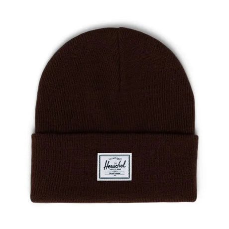 Brown knit beanie with a folded cuff and a label reading "Herschel" on the front.