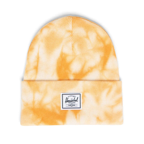 A yellow tie-dye beanie with a folded cuff and a white label featuring the brand "Herschel."