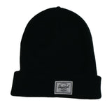 A black knit beanie hat with a folded cuff and a white label featuring the brand name "Herschel."