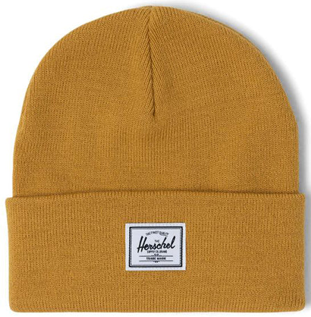 A mustard yellow knit beanie with a folded cuff and a black and white Herschel logo patch.