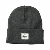 Gray knit beanie hat with a folded cuff and a white brand patch labeled "Herschel."