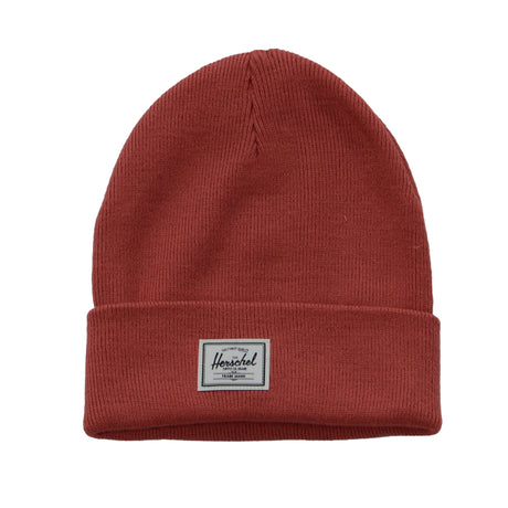 A red knit beanie hat with a folded cuff and a small Herschel label on the front.