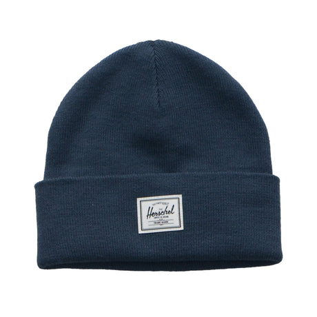A navy blue beanie hat with a folded cuff and a white tag that reads "Herschel" on it.