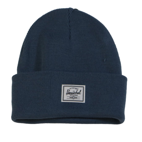 A dark blue ribbed beanie with a white Herschel label on the front.