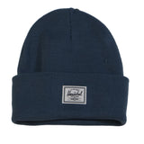 A dark blue ribbed beanie with a white Herschel label on the front.
