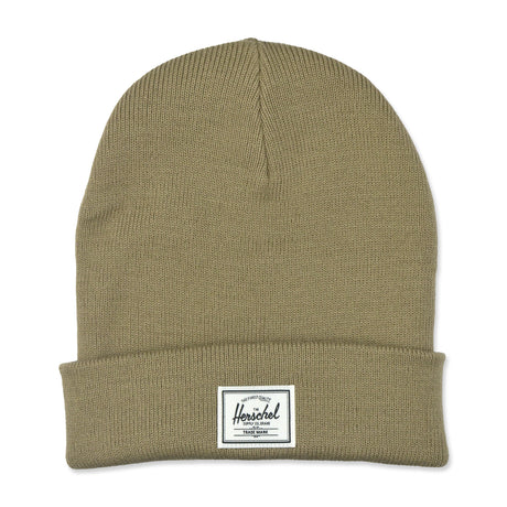 A khaki-colored knitted beanie hat with a folded cuff and a small rectangular brand label on the front.