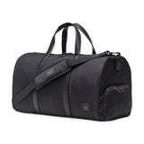 Black duffel bag with two top handles, a detachable shoulder strap, and a small zippered side pocket.