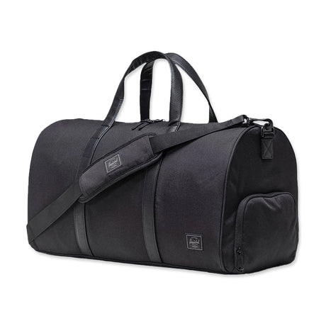 Black duffel bag with two top handles, a detachable shoulder strap, and a small zippered side pocket.