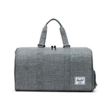 Gray duffel bag with two handles and a side zipper, featuring a white logo patch.