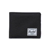 Black wallet with a white Herschel logo tag on the front.