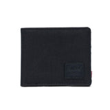 Black fabric wallet with a Herschel logo patch on the front.