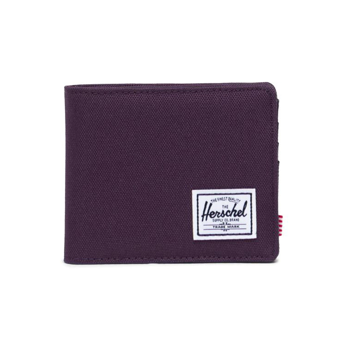 Purple wallet with a white Herschel logo patch on the front.