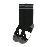 Black socks with gray stripes and a playful penguin design on the toes.