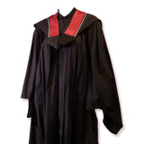Black graduation gown with a red and white collar.