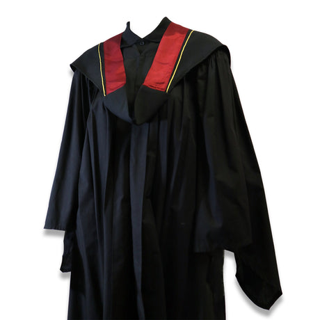 Black graduation gown with a red and gold-trimmed collar.