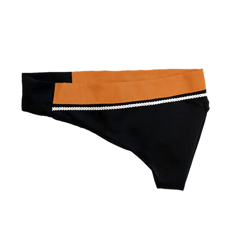 A pair of black and orange women's bikini underwear with a decorative white trim.