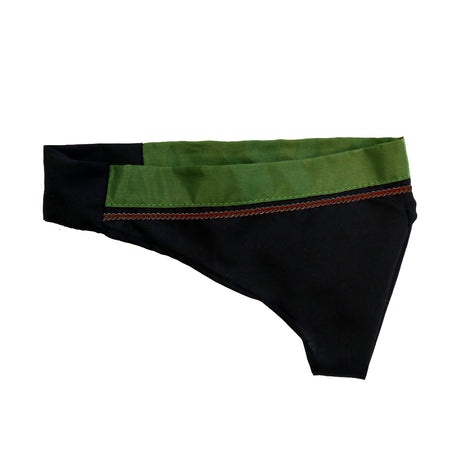 A black and green fabric item, possibly a piece of clothing or accessory, featuring a smooth green top section and a black lower section with decorative stitching.
