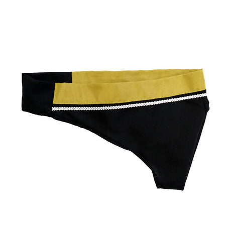 A black and gold fabric piece, resembling a headband or hair accessory, with a decorative white trim.