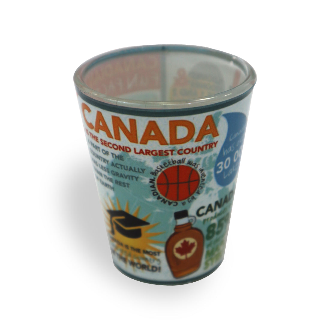A colorful shot glass featuring facts about Canada, including its size, a basketball icon, and a maple syrup bottle.