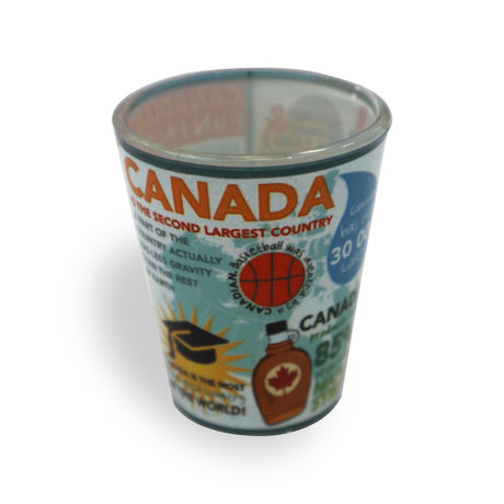 A colorful shot glass featuring facts about Canada, including its size, a basketball icon, and a maple syrup bottle.