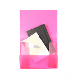 A pink folder holds two notebooks: one black and one with a beige cover featuring a stylized pen illustration.